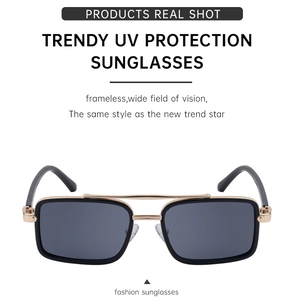 Detail view of polarized rectangular sunglasses featuring gold metal double bridge design