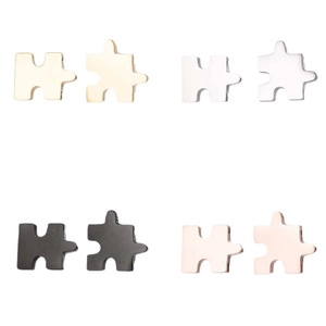 Geometric puzzle piece stud earrings set in gold silver black and rose gold finishes