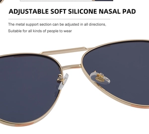 Close-up of adjustable soft silicone nose pads on aviator sunglasses with gold metal frame