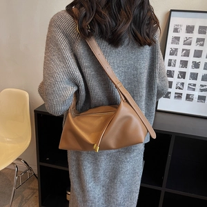 Minimalist soft brown leather tote bag with large capacity shown on a model in autumn style