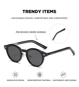 Détail du design à broches renforcées sur des lunettes de soleil rondes noires rétro