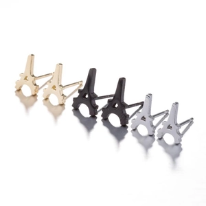 Detailed close-up of Eiffel Tower stud earrings set in gold, black, and silver finishes