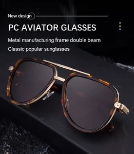 Detail of tortoise pilot sunglasses featuring a metal double bridge on a dark display
