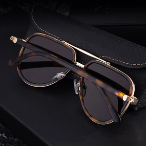 Close-up of aviator sunglasses with tortoise frame and premium black leather case