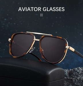 Detail of tortoise aviator sunglasses with gold metal bridge on leather case
