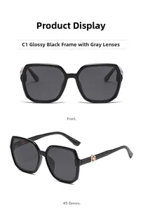 Detail of square black sunglasses showing the gold hexagonal hinge and dark gray lenses