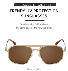 Close-up of gold metal frame sunglasses with dark brown lenses and double bridge design