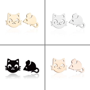 Detail showing cat and mouse asymmetrical stud earrings in four metallic color finishes