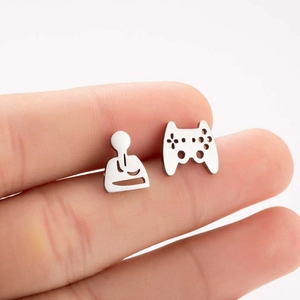 Detail showing asymmetric game controller and player stud earrings on fingertip