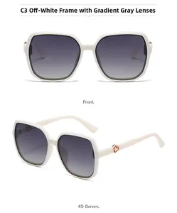 Close-up of cream square sunglasses with gradient gray lenses and gold hinge detail
