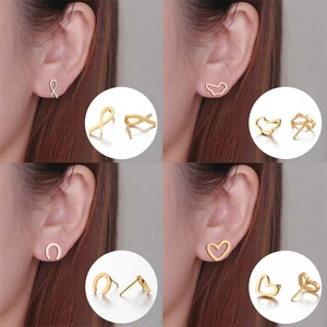 Minimalist gold geometric stud earrings set featuring heart and horseshoe designs