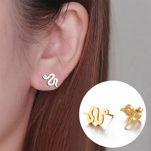 Detailed view of snake-shaped stud earrings in polished gold and silver finishes