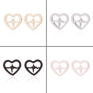 Macro detail of heartbeat-shaped stainless steel stud earrings in four metallic finishes