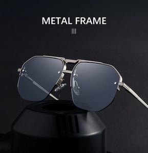 Detail of silver metal frame and dark grey lenses on modern semi-rimless sunglasses