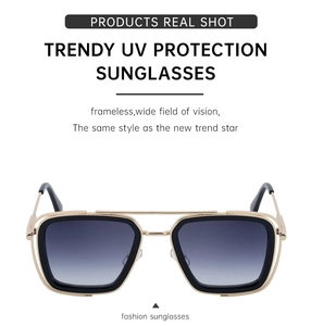 Detail of square frame sunglasses with gold-tone hollow bridge and grey gradient lenses