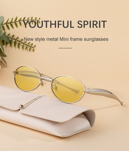 Top-down view of oval silver metal sunglasses with yellow lenses and a leather case