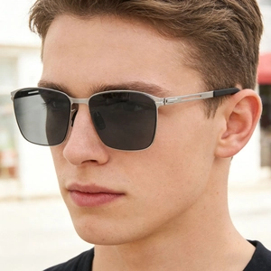 Close-up of polarized square nylon sunglasses with matte silver stainless steel frame on a model