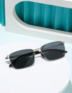 Minimalist square silver metal sunglasses with black polarized nylon lenses on a white podium