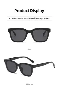 Détails de lunettes de soleil carrées noires avec verres gris et rivets argentés