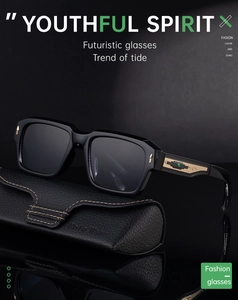 Detail of square black sunglasses with gold accents and emerald gem on a leather case