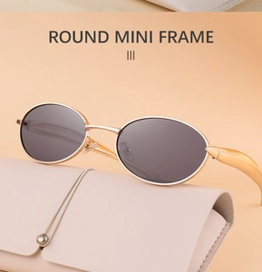 Macro detail of retro mini round sunglasses with gold metal frame and stylish leather case