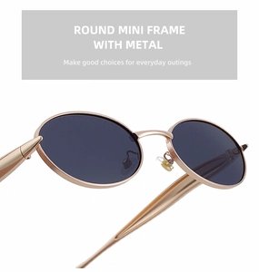 Close-up of rose gold oval metal sunglasses featuring soft silicone nose pads and grey lenses