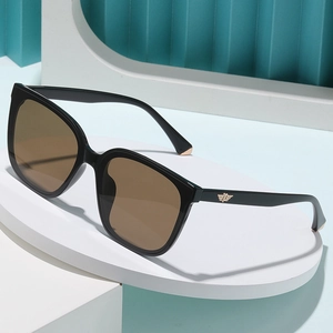 Women's chic oversized square polarized sunglasses with golden wing detail and brown lenses