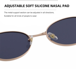 Detailed view of adjustable silicone nose pads on oval metal frame sunglasses