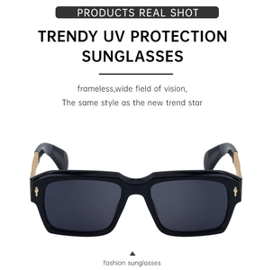 Detail of square polarized sunglasses with golden metal hinges and rivets design