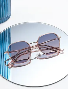 Detail of rose gold hexagonal polarized sunglasses with gradient purple lenses and mirror reflection