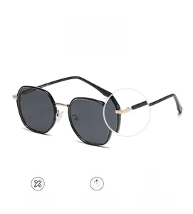 Detail shot of sturdy gold hinges and sleek temples on square polarized sunglasses