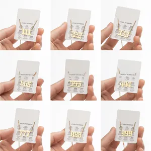 Macro shot of nine golden angel number necklaces from 111 to 999 on message cards