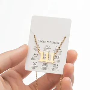 Close-up of golden 111 angel number pendant necklace with meaning card display