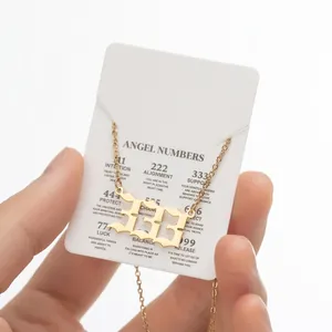 Detail of gold angel number 333 pendant necklace on jewelry card with meanings