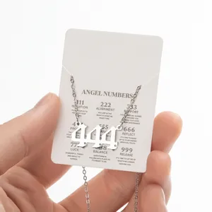 Detail of silver angel number 444 pendant with gothic digits and meaning card