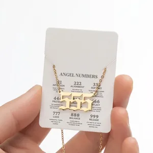 Close-up of gold 555 angel number necklace with gothic pendant and meaning card