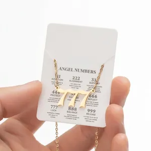 Detailed view of gold 777 angel number pendant necklace with meaning display card