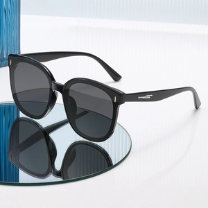 Classic black square polarized sunglasses with silver metal accents on a reflective surface