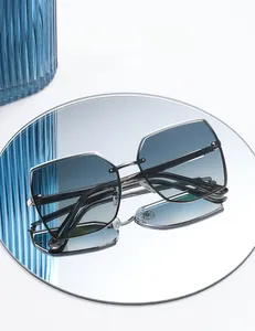 Detail of rimless nylon sunglasses with silver metal frame reflected on a mirror