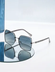 Detail of square polarized sunglasses with blue gradient lenses on a mirrored surface