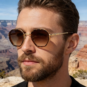Detail of octagonal tortoiseshell sunglasses with gold metal screws on the temples