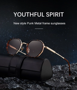 Close-up of punk metal frame sunglasses with dark lenses on a black leather case