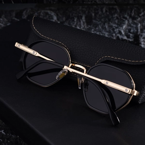 Close-up of retro square sunglasses with gold metal temples and leather case