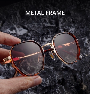 Close-up of tortoise shell sunglasses with gold metal frame and geometric polygon design