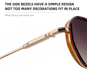 Detail of gold metal temple and amber frame hinges on these retro sunglasses