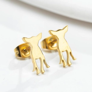 Macro shot of gold Chihuahua shaped stud earrings with polished metallic finish