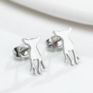 Macro shot of silver minimalist Chihuahua silhouette stud earrings with polished finish