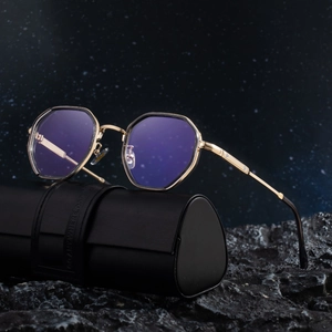 Retro hexagonal gold metal sunglasses with blue lenses and leather case on rock