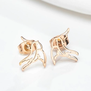 Macro shot of rose gold swallow bird stud earrings with hollow design and butterfly backs