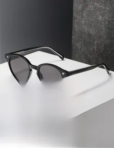Detail of retro round frame sunglasses with silver wing metal hinges on a white stand